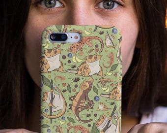 May include: A green phone case with a repeating pattern of brown and white geckos, leaves, and other small details.
