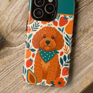 May include: A teal and cream phone case featuring a cartoon poodle wearing a blue bandana with white polka dots. The case is decorated with strawberries, oranges, papaya, and floral elements.