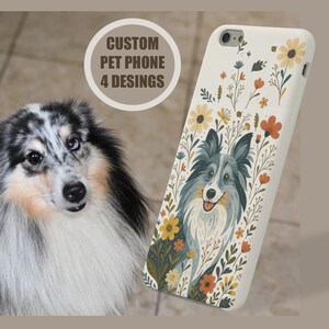 May include: A white phone case featuring a blue and gray dog illustration surrounded by flowers. The text "CUSTOM PET PHONE 4 DESIGNS" is in a circular design. A real dog with blue eyes is in the background.