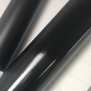 May include: Two rolls of black vinyl wrap, one with a matt finish and the other with a glossy finish.