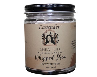 May include: A glass jar with a black lid, containing white whipped shea butter. The label reads "Lavender", "SHEA-LIFE Be natural, be you. Whipped Shea BODY BUTTER 9 oz / 266 ml". The jar is filled with 266 ml of body butter.