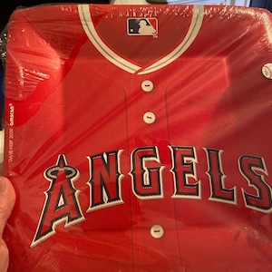 May include: Red and white baseball jersey paper plate with the word "ANGELS" in black and white lettering. The MLB logo is in the top center of the plate.