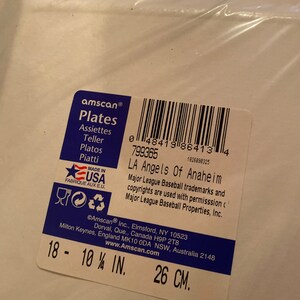 May include: Amscan brand white paper plates with the text "Plates" and "LA Angels of Anaheim". The plates are 10 1/4 inches in diameter or 26 centimeters.