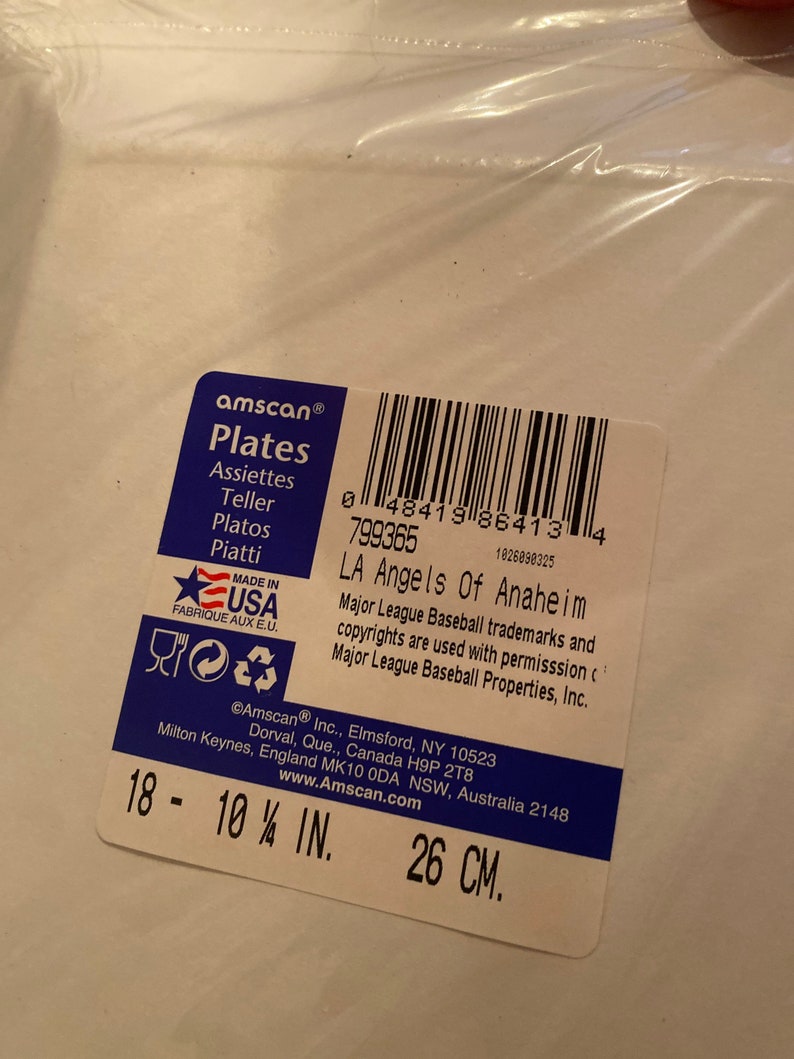 May include: Amscan brand white paper plates with the text "Plates" and "LA Angels of Anaheim". The plates are 10 1/4 inches in diameter or 26 centimeters.