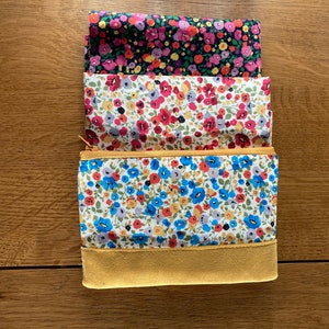 Ditsy poppy mini makeup bags in black or white fabric with velvet trim. Handmade Small Cosmetic brush bag, sanitary pouch or coin purse.
