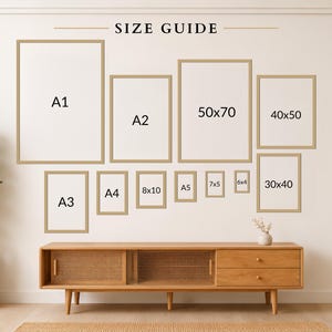a wall with a series of framed artworks arranged in a grid-like pattern, providing a size guide for the different frame sizes.