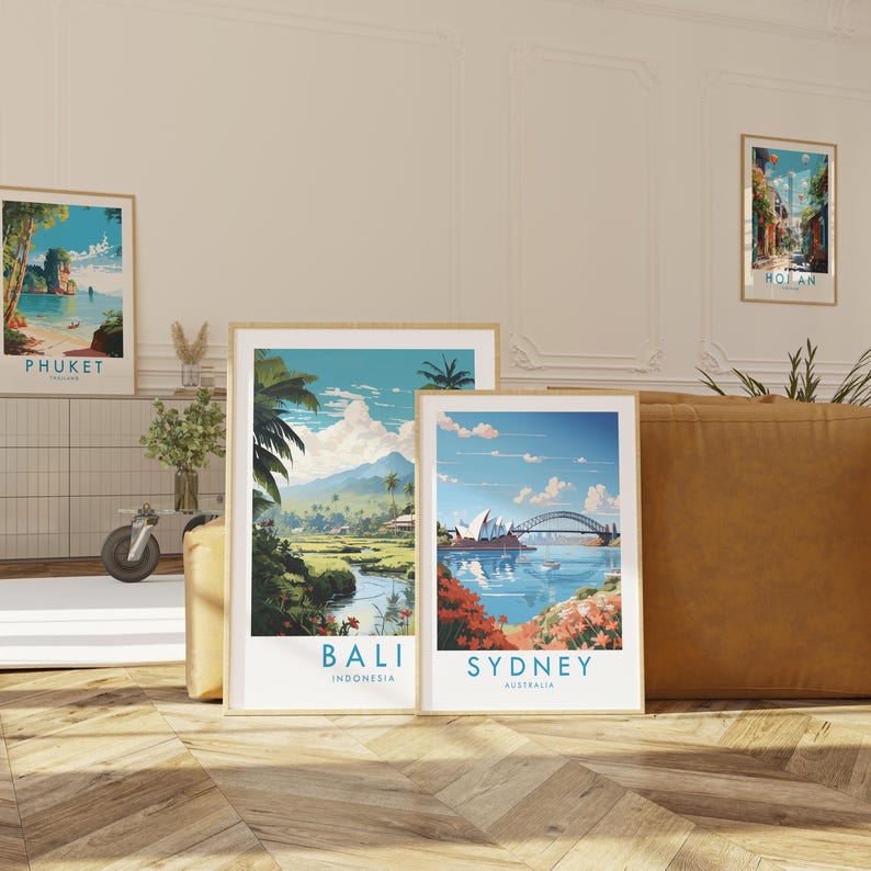 two framed travel posters, each depicting a different country: Bali, Indonesia, and Sydney, Australia.