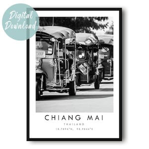 May include: Black and white photograph of several tuk-tuks, a common mode of transportation in Thailand, lined up on a street. The image is framed with a black border and includes the text "CHIANG MAI, THAILAND" at the bottom, along with coordinates.