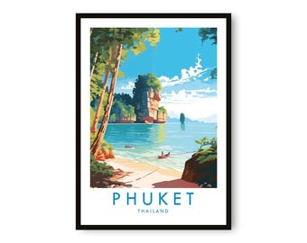 May include: A framed art print of Phuket, Thailand. The image depicts a tropical beach scene with turquoise water, a sandy shore, and a large rock formation. The sky is blue with white clouds. The word "PHUKET" and "THAILAND" are printed at the bottom.