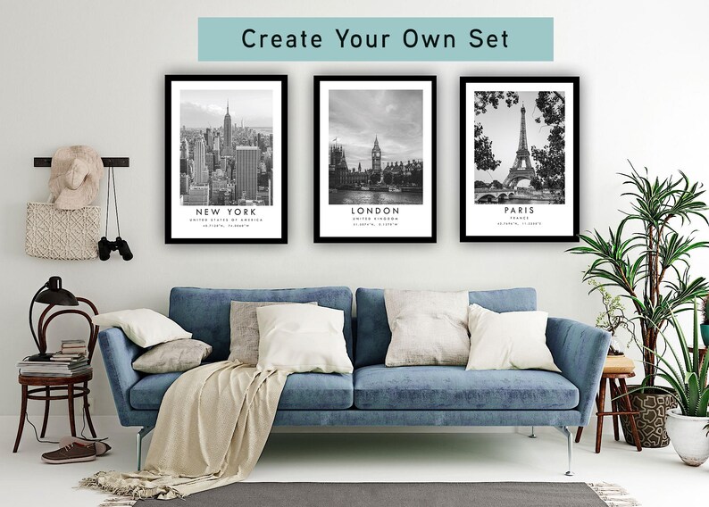 a living room with a blue sofa, a potted plant, and three framed pictures of famous landmarks in New York, London, and Paris.