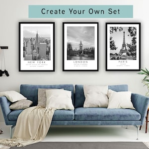 a living room with a blue sofa, a potted plant, and three framed pictures of famous landmarks in New York, London, and Paris.