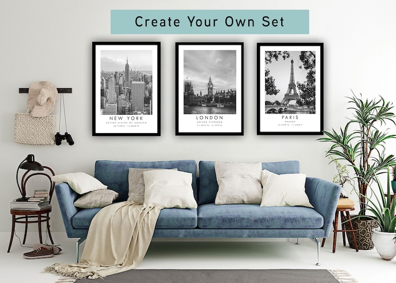 a living room with a blue sofa, a potted plant, and three framed pictures of famous landmarks in New York, London, and Paris.