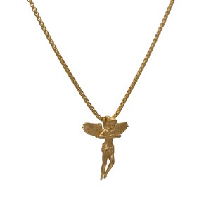 May include: A gold chain necklace with a gold angel pendant. The angel is depicted with wings outstretched and a serene expression.