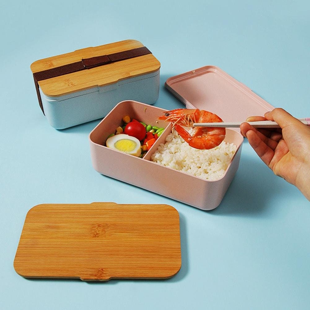 Personalized Eco Friendly Bento Box Lunch Box And Blue And Etsy a-plastic-container-filled-with-food-on-top-of-a-table