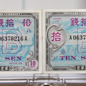 May include: Two vintage Japanese military currency notes. Each note features purple and blue designs, Japanese characters, and the text "TEN SEN." The notes have serial numbers and a "10" denomination.