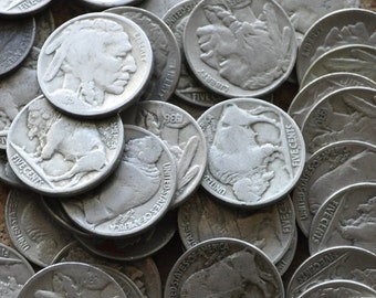 May include: A collection of vintage silver-colored US five-cent coins featuring the profile of an American Indian, a buffalo, and the words "United States of America" and "Five Cents".