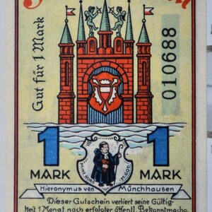 Könnte beinhalten: Vintage deutsche 1-Mark-Note aus Rinteln mit einer detaillierten Illustration eines Schlosses mit rotem Mauerwerk und grünen Türmen. Die Note enthält deutschen Text und eine Seriennummer.