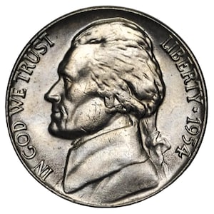 May include: A silver 1954 Jefferson nickel. The obverse features a profile of Thomas Jefferson, with the inscriptions "IN GOD WE TRUST" and "LIBERTY". The year "1954" is also visible.