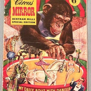 May include: A vintage Circus Mirror magazine cover featuring a large chimpanzee illustration above a circus ring with a tiger, elephant, horse, and performers. The text reads Circus Mirror, Bertram Mills Special Edition, 6d, and My Daily Bout With Danger.