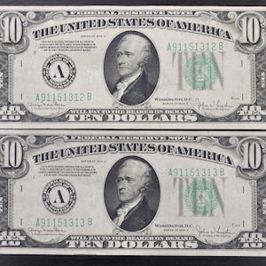 May include: Two $10 US Federal Reserve Notes, Series of 1934, featuring a portrait of Alexander Hamilton. The notes have the serial numbers A91151312 B and A91151313 B. The notes are in good condition and have a green and black colour scheme.
