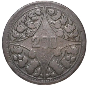 May include: A circular dark metal coin featuring the number 200 embossed in the centre. The design includes four symmetrical sections of stylised floral or leaf patterns surrounding the central numeral, all set within a raised circular border.