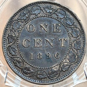 May include: A silver Canadian one cent coin from 1896 with a wreath of maple leaves around the edge. The coin reads "ONE CENT 1896".