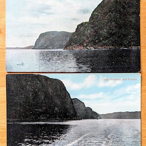 May include: Two vintage postcards showing views of the Saguenay River. The top card displays Trinity Rock and Eternity Cape, with red text. The bottom card shows Capes Eternity and Trinity. Both cards depict dark cliffs and water.