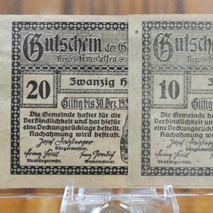 May include: Three vintage paper vouchers from the municipality of Dorf Haag, Germany, dated 30 December 1920. The vouchers are for 50, 20, and 10 Heller, respectively. Each voucher features a unique design and the text "Gutschein der Gemeinde Dorf Haag" (Voucher of the municipality of Dorf Haag).