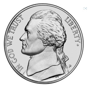 May include: A silver US nickel coin with the profile of Thomas Jefferson on the obverse side. The coin features the inscription "IN GOD WE TRUST" and "LIBERTY".