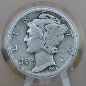 May include: A silver US Liberty Head nickel coin with the year 1928, the words "Liberty", "In God We Trust", and "E Pluribus Unum" inscribed around the edge.