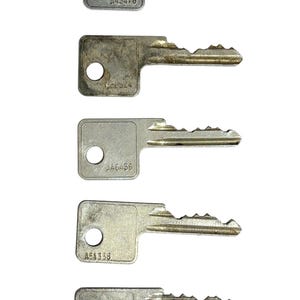 May include: Five silver-colored metal keys arranged vertically. Each key features a rectangular head with a circular hole and a unique bitting pattern on the blade. The keys are stamped with the codes A43476, A46524, A46436, A64338, and A22525.