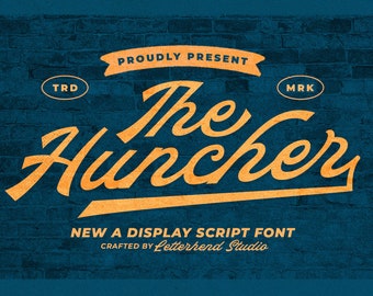 May include: A graphic design featuring the words "The Huncher" in a stylized, orange script font. The text is set against a textured, dark blue brick wall background. Additional text includes "Proudly Present" and "New A Display Script Font."