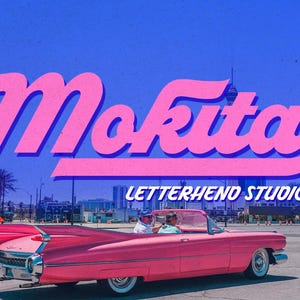 May include: A pink vintage convertible car with two people inside, driving past a building with the text "Mokita LETTERHEND STUDIO" in a pink and blue font.