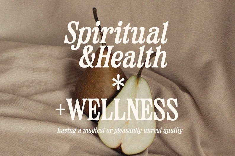 May include: Two pears, one whole and one cut in half, on a brown fabric background. The text "Spiritual & Health * WELLNESS having a magical or pleasantly unreal quality" is written in white on the fabric.