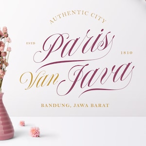 May include: A white background with a pink and gold logo that reads "Authentic City Paris Van Java Estd 1810 Bandung, Jawa Barat". A bouquet of pink dried flowers in a pink vase is on the left side of the image.