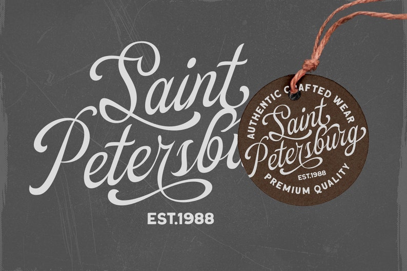 May include: A brown leather tag with white text that reads "Authentic Crafted Wear Saint Petersburg Est. 1988 Premium Quality". The tag is attached to a brown string.