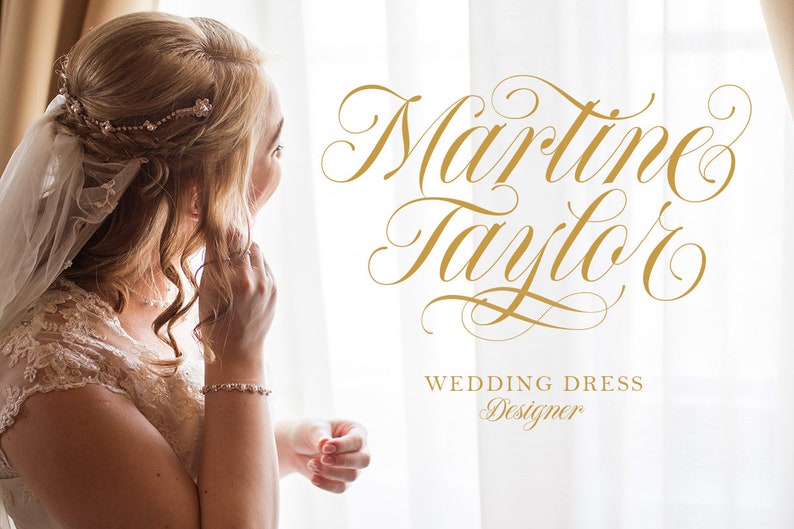 May include: A bride in a white lace wedding dress with a veil, looking out a window. The text "Martine Taylor Wedding Dress Designer" is written in gold script.