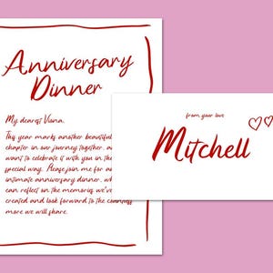 May include: A white card with red handwritten text. The card reads "Anniversary Dinner" and includes a message to "My dearest Viana". A smaller white card with red handwritten text reads "from your love Mitchell" and includes two red hearts.