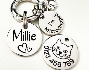 May include: Silver cat pet ID tag with a cat face, the name Millie, two hearts, and the text "I'm Microchipped" and a phone number 0123 456 789.