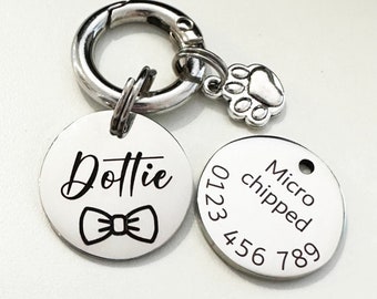 May include: Silver dog tag with the name Dottie and a bow tie engraved on it. A second silver tag has the text Micro chipped and the numbers 0123 456 789 engraved on it.