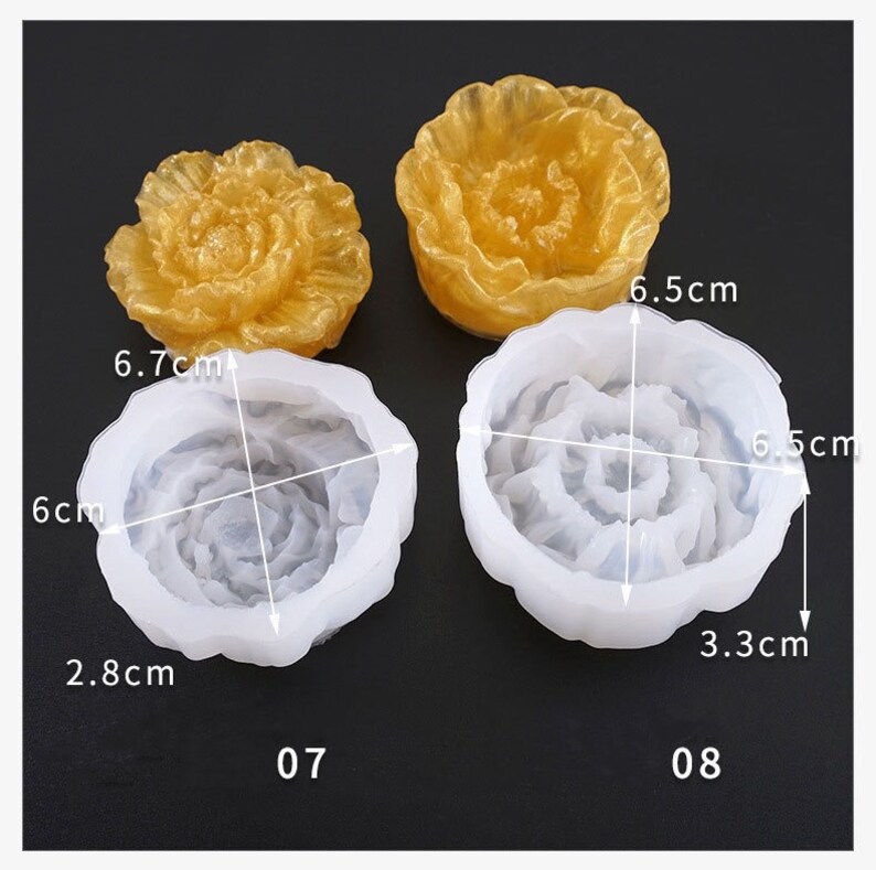 May include: Two flower-shaped molds, one gold and two white, with measurements. The gold flower is solid, while the white ones are molds. One white mold is 6 cm by 6.7 cm, and the other is 6.5 cm by 6.5 cm. The molds are for crafting.