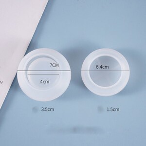 May include: Two white silicone molds for resin crafts. The larger mold is 7 inches in diameter and 4 inches deep. The smaller mold is 6.4 centimeters in diameter and 1.5 centimeters deep.