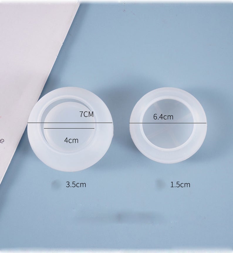 May include: Two white silicone molds for resin crafts. The larger mold is 7 inches in diameter and 4 inches deep. The smaller mold is 6.4 centimeters in diameter and 1.5 centimeters deep.