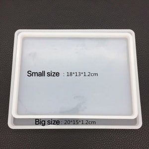 May include: Two white rectangular silicone molds, one slightly smaller than the other, are stacked. The smaller mold is 7.1 x 5.1 x 0.5 inches, and the larger mold is 7.9 x 5.9 x 0.5 inches. Text on the image indicates the sizes.