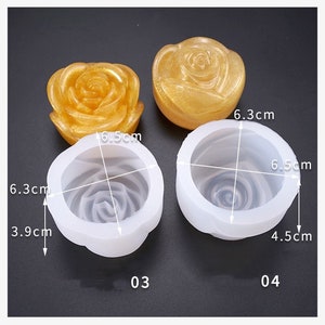 May include: Four rose-shaped molds are displayed. Two are solid, golden-yellow, and two are white silicone molds with internal rose detailing. Measurements are provided: 6.5 cm diameter, 6.3 cm height, and 3.9 cm and 4.5 cm depths. Numbers 03 and 04 are printed on the molds.