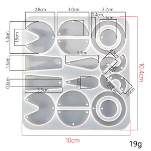May include: A clear silicone mold with 14 different shapes for making jewelry. The mold measures 10.4 cm by 10 cm and weighs 19 grams. The shapes include circles, ovals, teardrops, and half-circles.