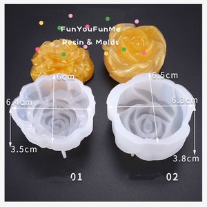 May include: Two rose-shaped resin moulds, one clear and one gold, with the text "FunYouFunMe Resin & Molds." The clear mould is 6.4 cm wide, 6 cm long, and 3.5 cm deep. The gold resin is 6.5 cm wide. The second clear mould is 6.3 cm wide and 3.8 cm deep.