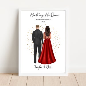 May include: A framed print featuring an illustration of two people standing back to camera. The text reads Her King, His Queen, RADCLIFFE SCHOOL 2023, and Taylor & Jess. One person wears a black suit, the other a red gown with gold stars behind them.