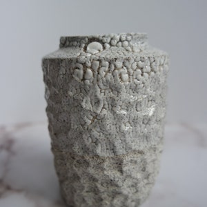 Carved black and white speckled vase