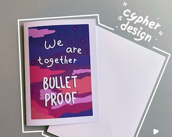 May include: A card with a purple, pink and orange sunset background. The text "We are together bullet proof" is written in white on the card.